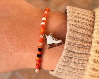 Pulsera de cuentas con dije de patín de hielo