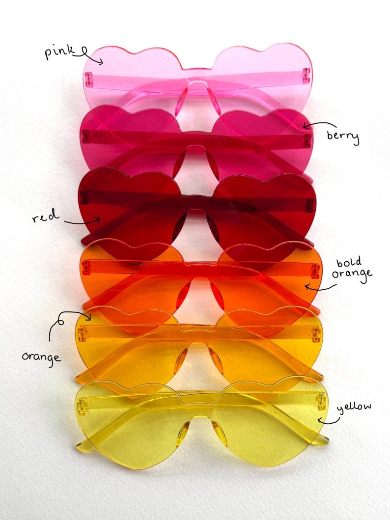 May include: A collection of heart-shaped sunglasses in various colors, including pink, berry, red, bold orange, orange, and yellow. The sunglasses are arranged in a vertical stack, showcasing their vibrant hues and unique design.