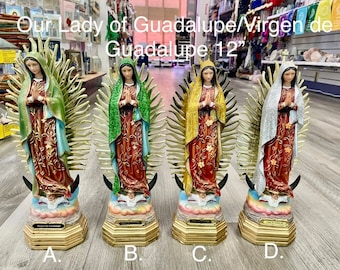May include: Four 12-inch Our Lady of Guadalupe Virgin de Guadalupe statues. The statues are made of resin and are painted in different colors: green, gold, white, and silver. Each statue is standing on a gold base with the words "Virgen de Guadalupe" written on it.