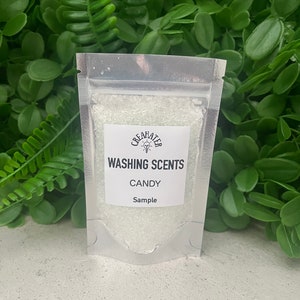 May include: A small clear plastic bag filled with white crystals. The bag has a white label that says "Washing Scents" with the words "Candy" and "Sample" underneath.