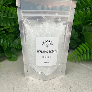 May include: A silver resealable pouch filled with clear crystals labelled "Washing Scents" with the scent name "Beautiful" and the word "Sample".