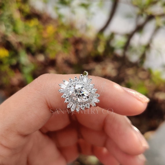 Oval starburst engagement ring discount