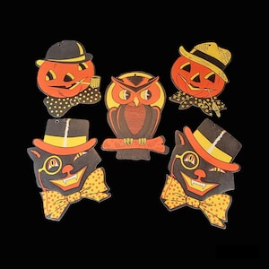 May include: Five vintage Halloween paper cutouts. A black cat with a top hat and bow tie, a black and orange owl, and three jack-o'-lantern faces with top hats and bow ties.