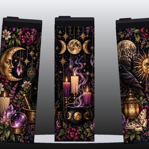 May include: Three cylindrical tumblers featuring a dark, celestial-themed print. The design includes golden moons, suns, stars, purple and white candles, a black cauldron with purple smoke, crystals, flowers, a raven, and a moth.