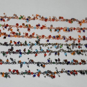 May include: Five strands of beaded necklaces with colourful glass beads and silver chain links. The beads are in various colours, including red, blue, green, white, and orange.