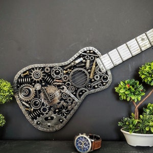 Decorative guitar handmade with scrap metal car parts, nuts, bolts, metal strings