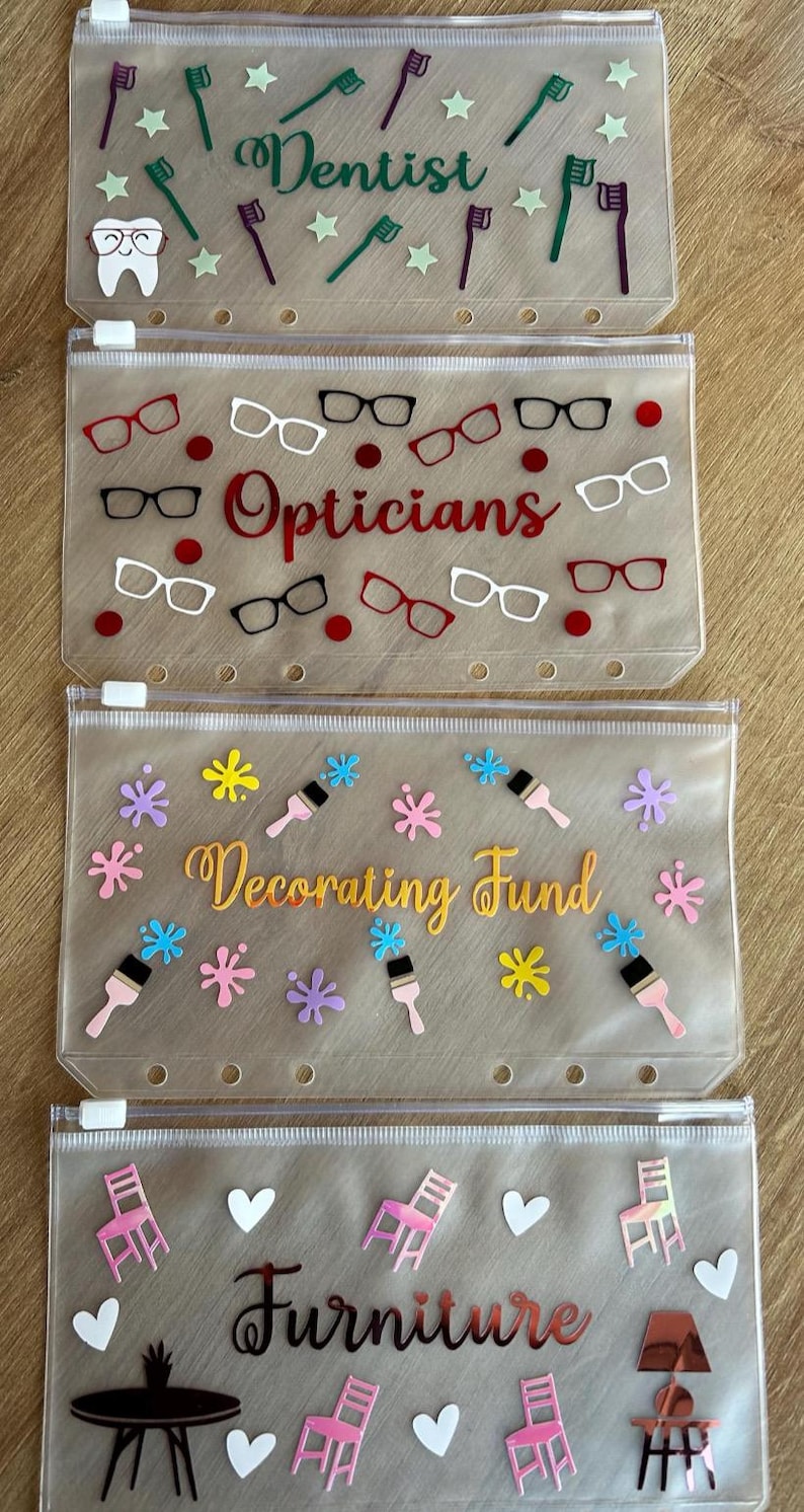 May include: Four translucent, rectangular zipper pouches with six holes along the bottom edge. The top pouch features toothbrushes, stars, a tooth, and the word Dentist. The second has glasses and the word Opticians. The third has paintbrushes, splatters, and Decorating Fund. The fourth has chairs, hearts, and Furniture.