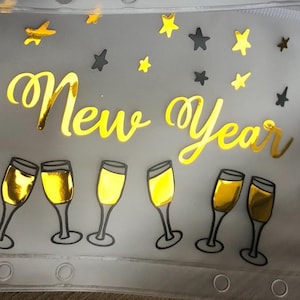 May include: A translucent zippered pouch featuring the gold foil text New Year. The design includes gold foil illustrations of six champagne flutes and various star shapes scattered across the surface. The pouch has a row of circular holes along the bottom edge.