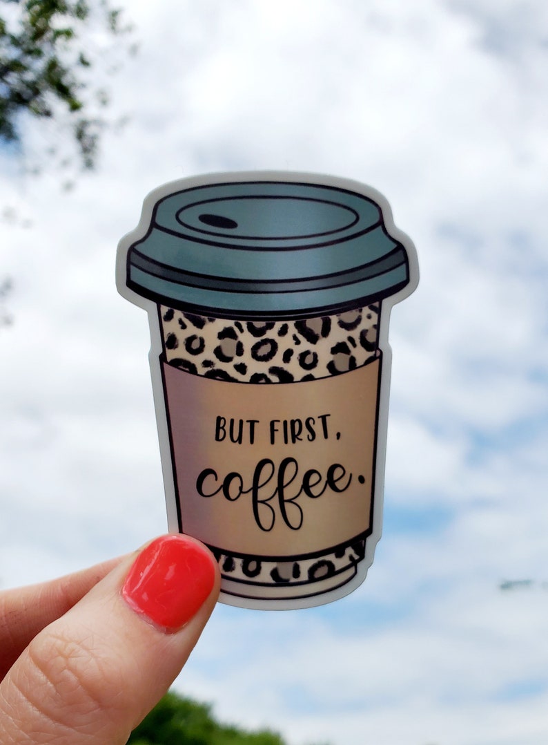 May include: A sticker of a coffee cup with a leopard print design and the text "But first, coffee."