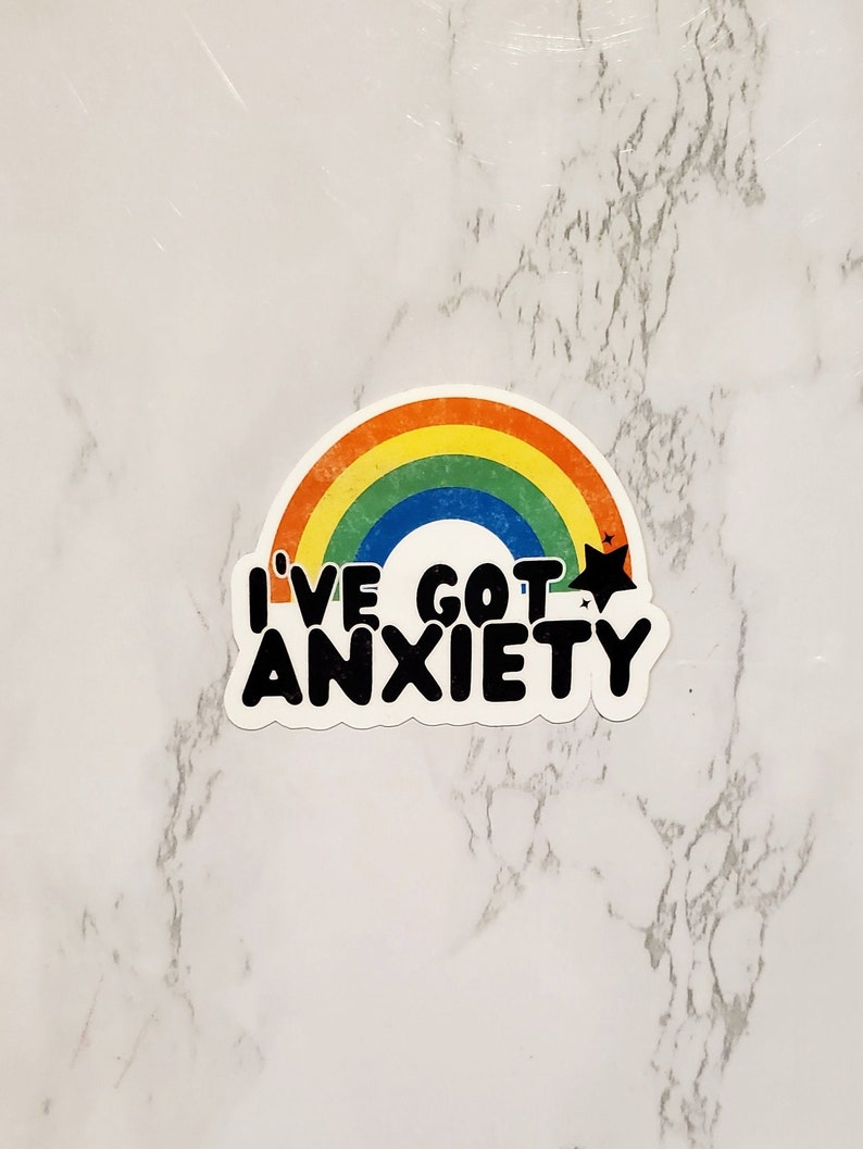 May include: A rainbow sticker with the text "I've got anxiety" in black lettering. The sticker has a distressed look and a star above the text.