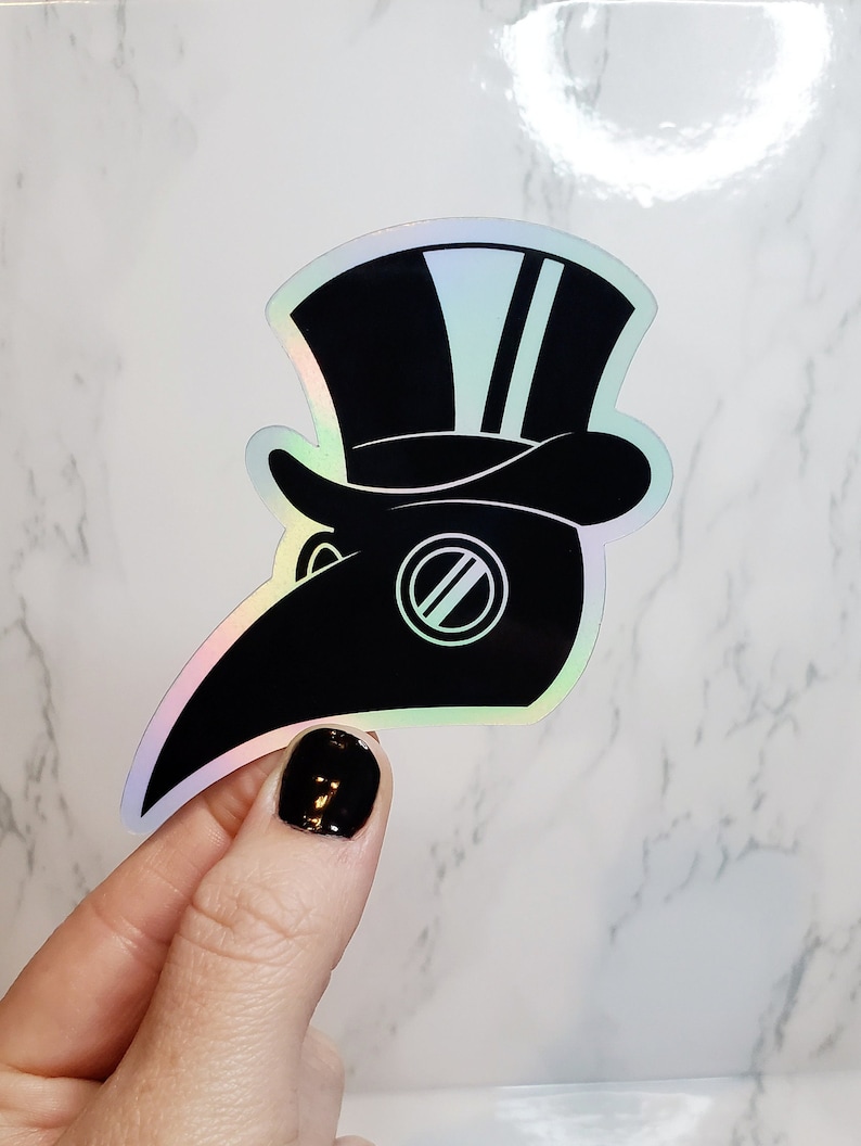 May include: A black and white iridescent sticker of a plague doctor wearing a hat with two stripes. The sticker has a holographic finish.
