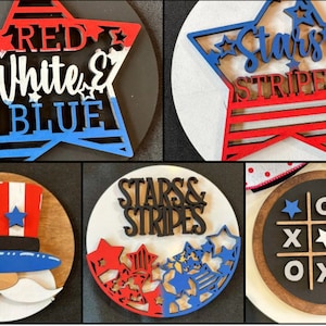 May include: Four wooden signs with patriotic themes. The first sign is a red, white, and blue star with the text "RED WHITE & BLUE". The second sign is a red, white, and blue star with the text "Stars & Stripes". The third sign is a red, white, and blue Uncle Sam hat with a white beard. The fourth sign is a black and white tic-tac-toe board with red, white, and blue stars.