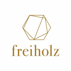 May include: A geometric logo with a gold outline of a hexagon with intersecting lines. The text "freiholz" is written below the logo in gold.