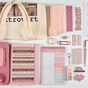 May include: A flat lay of a premium book-themed bundle in shades of pink and cream. Includes a tote bag, planner, socks, stickers, pens, and a reading log. The tote bag reads "Booktrovert".