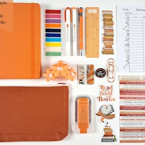 May include: An orange basic bundle with a notebook, highlighters, pens, stickers, a bookmark, and a reading log. The bundle includes a pencil case, a flower hair clip, and a small reading light. The text "Read good Books" is visible.