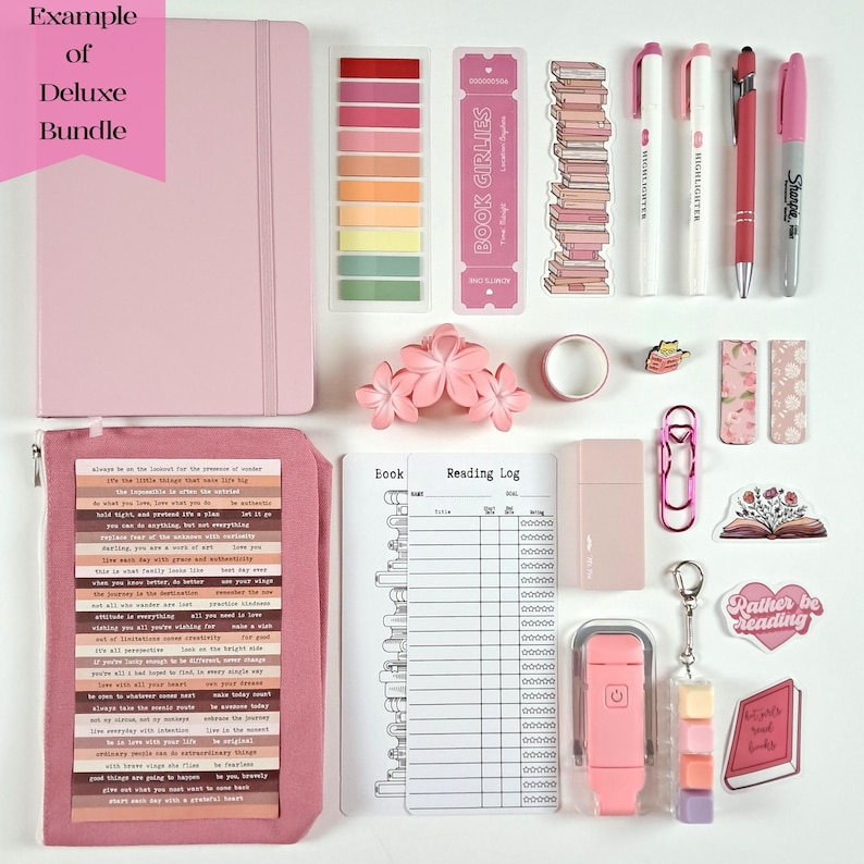 May include: A pink deluxe bundle with a notebook, sticky notes, bookmarks, pens, highlighters, and stickers. The bundle includes a reading log, a pink paper clip, and a keychain with colorful cubes. The text "BOOK GIRLIES" is visible.