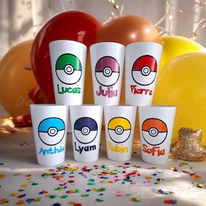 May include: Seven white plastic cups with a Pokeball design and names printed on the front. The cups are arranged in a semi-circle on a white surface with colorful confetti.