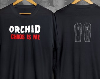 May include: Black t-shirt with white text that reads "Orchid Chaos is Me" on the front and two white coffin designs on the back.