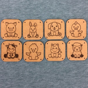 May include: Eight wooden squares with different animal designs. Each square has a brown background and a black outline. The animals include a pig, rabbit, dog, chick, cow, chick, horse, and lamb.