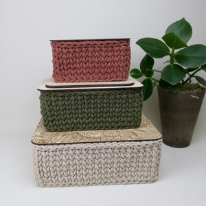 Personalized rectangular storage baskets in various sizes and colors with a choice of motifs for wooden lids.