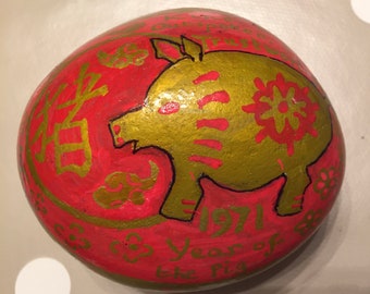 Various examples of Painted pebbles covering birthdays. Chinese Zodiac for years or flowers for months.