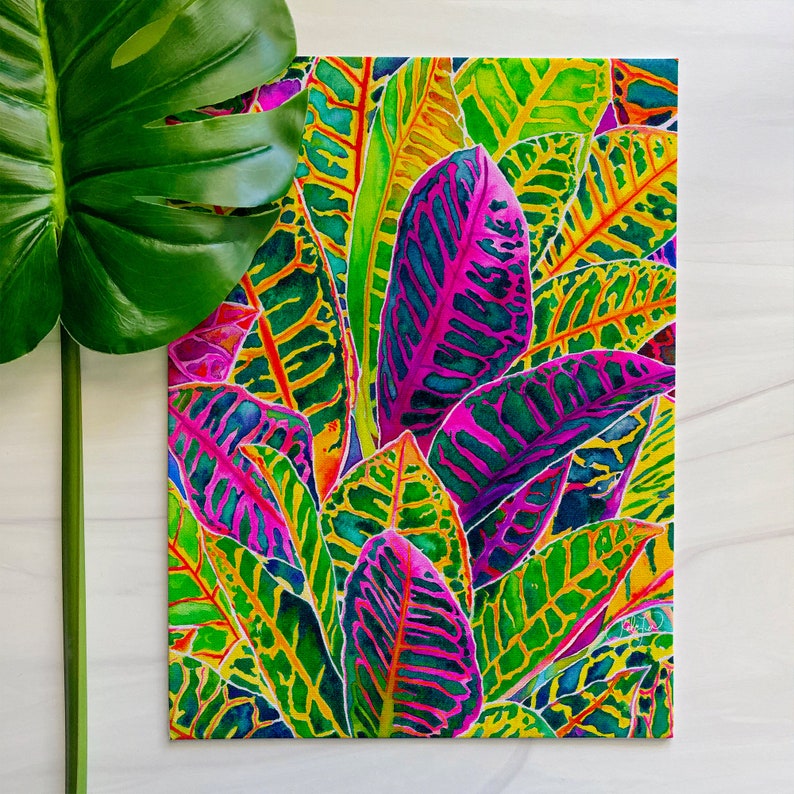 Puede incluir: Pintura de acuarela de follaje tropical con hojas vibrantes de color verde, amarillo, rosa y morado.
