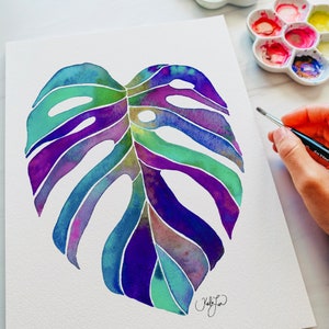 May include: Watercolor painting of a large, tropical monstera leaf in shades of purple, blue, and green. The leaf is painted on a white background.