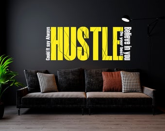 May include: A motivational wall decal with the word "Hustle" in yellow with black cracks and the text "Believe in you, Do your best" in white on a black wall. A black couch with pillows is in the foreground.