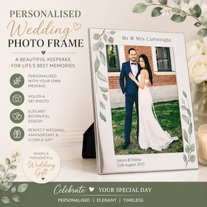 May include: A silver photo frame with a botanical design, holding a 12.7 x 17.8 cm photo of a couple. The frame is personalised with the names "James & Emma" and the date "25th August 2023". Text on the frame reads "Personalised Wedding Photo Frame".