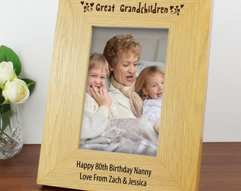 May include: A light-colored wooden picture frame with the words "Great Grandchildren" at the top. The frame holds a photo of a woman and two children. The bottom of the frame reads "Happy 80th Birthday Nanny Love From Zach & Jessica."