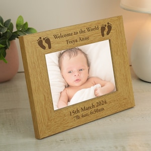 May include: A wooden photo frame with a baby photo inside. The frame is engraved with the text "Welcome to the World Freya Anne" and "15th March 2024 7lb 4oz, 6:30am".