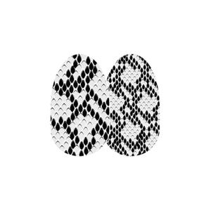 May include: Two black and white oval shaped nail wraps with a snake skin pattern.