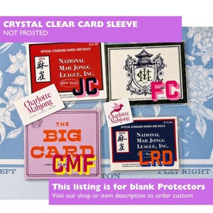 May include: Four rectangular clear plastic card sleeves containing various Mah Jongg rule cards. The cards feature text including National Mah Jongg League, Inc., The Big Card, and Charlotte Mahjong. The sleeves are transparent and protective.