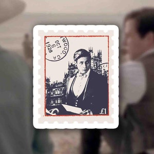 May include: A vintage postage stamp featuring a black and white image of a man in a suit and hat standing in front of a building. The stamp is red, white, and blue with the text "C.G.A. 1928 OCT. 00" and "£1" printed on it.