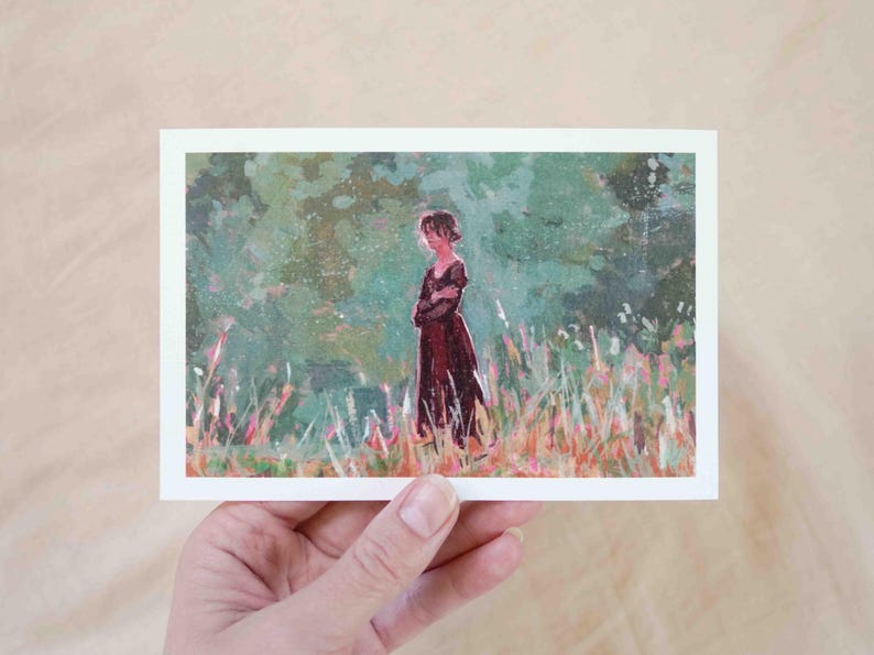 May include: A postcard with an illustration of a person in a long, dark red dress standing in a field of tall grass. The background is a blend of green and light colours, creating a soft, painterly effect.