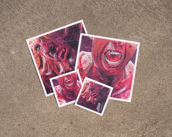 May include: Four square art prints featuring expressive, painterly portraits in shades of red, pink, and purple. The images depict faces with intense, open-mouthed expressions, visible teeth, and splattered paint textures on a white border.
