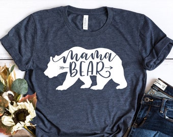 May include: A navy blue t-shirt with a white graphic of a bear with the text "mama bear" and an arrow pointing to the right.