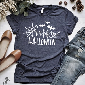May include: A dark blue t-shirt with a white graphic design that says "Happy Halloween" with bats and spiderwebs.