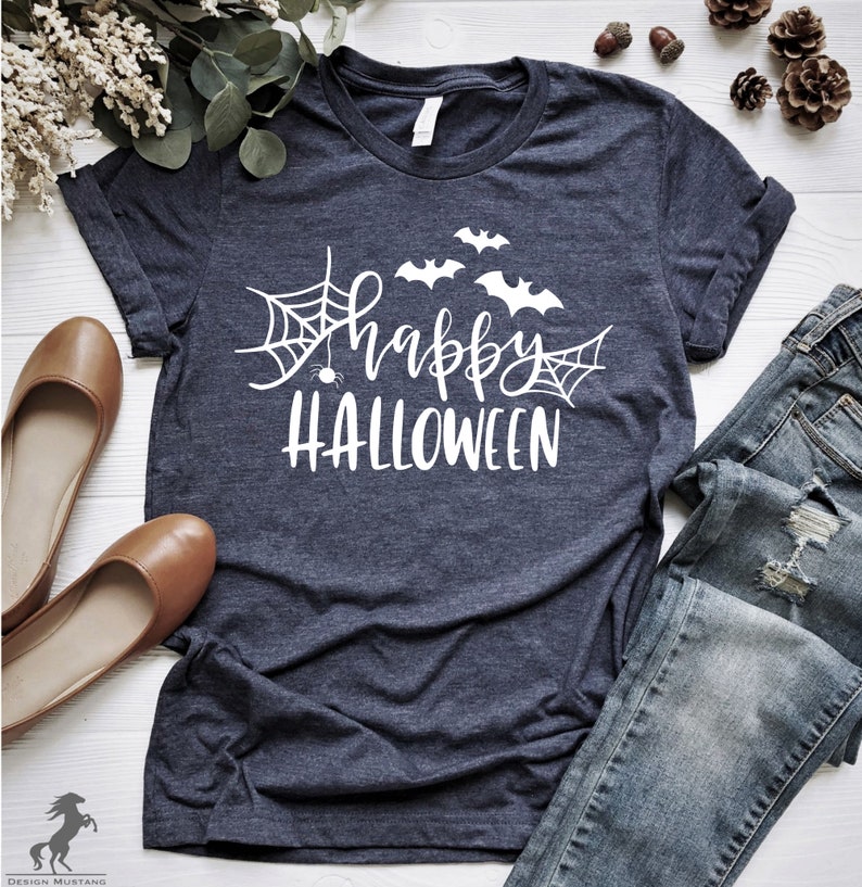 May include: A dark blue t-shirt with a white graphic design that says "Happy Halloween" with bats and spiderwebs.