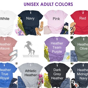 May include: A collage of 18 t-shirts in various colors, including black, white, navy, pink, red, teal, maroon, mauve, purple, olive, peach, sunset, royal, heather, grey, midnight navy, and burnt orange. The t-shirts are arranged in a grid pattern and each t-shirt has a different color and text label.