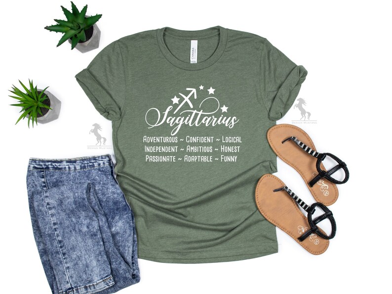 May include: Green t-shirt with white text that reads "Sagittarius" and lists personality traits: "Adventurous - Confident - Logical - Independent - Ambitious - Honest - Passionate - Adaptable - Funny".