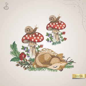 May include: An embroidered design featuring a sleeping fawn, two red and white spotted mushrooms with snails, and sprigs of berries and greenery. The word "DIGITAL" is in a gold rectangle.
