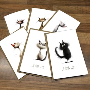 May include: Six blank greeting cards with brown envelopes. Each card features a cartoon cat illustration with the text "A little note" on the bottom.