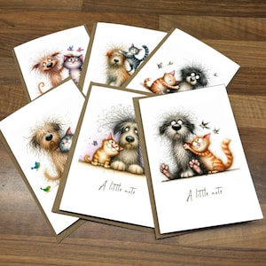 May include: A selection of greeting cards with charming illustrations of dogs and cats. Each card has a white background and a brown border. Some cards feature the text "A little note". The illustrations show the animals in different poses, with butterflies and birds.