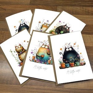 May include: A set of greeting cards with charming cat illustrations amidst vibrant flowers in pots. Each card has a brown border and the text "A little note". The cats are depicted in various colours and poses, creating a playful aesthetic.