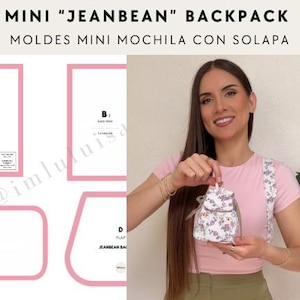 May include: A pink and white floral mini backpack with a flap closure. The backpack is shown on a white background with a pink and white floral pattern. The text "MINI "JEANBEAN" BACKPACK" is at the top of the image. The text "MOLDES MINI MOCHILA CON SOLAPA" is below the backpack.
