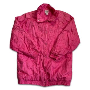 May include: Bright pink vintage jacket with a button-up front, collared neckline, and elastic cuffs and hem. The jacket has a relaxed fit and a lightweight, slightly shiny material. A small label is visible near the collar.
