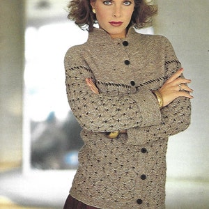 May include: A brown knitted cardigan with a button-up front and a high collar. The cardigan has a textured pattern and brown trim around the edges.