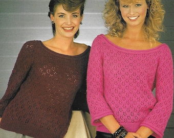May include: Two women wearing knitted sweaters with openwork patterns. The sweater on the left is burgundy and the sweater on the right is pink.