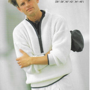 May include: A white knitted sweater with a black zip and trim. The sweater has a ribbed collar and cuffs. The model is wearing white trousers and a black hat. Sizes: 92-97, 102-107, 112-117 cm (36"-38", 40"-42", 44"-46").